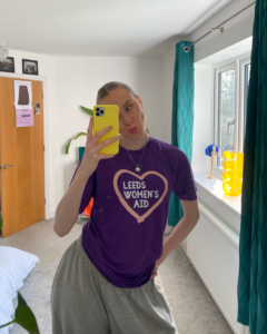 Selfie of Erin from the women's cricket team in mirror wearing her LWA tshirt